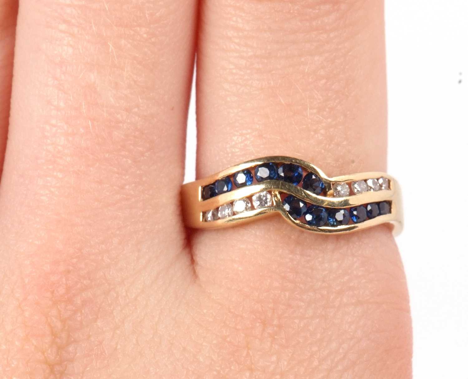 A 14ct sapphire and diamond ring, the two strand crossover style ring set with small round sapphires - Image 9 of 9