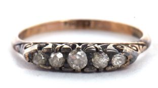 An 18ct five stone diamond ring, the graduated old mine cut diamonds, claw set to a scrolled gallery