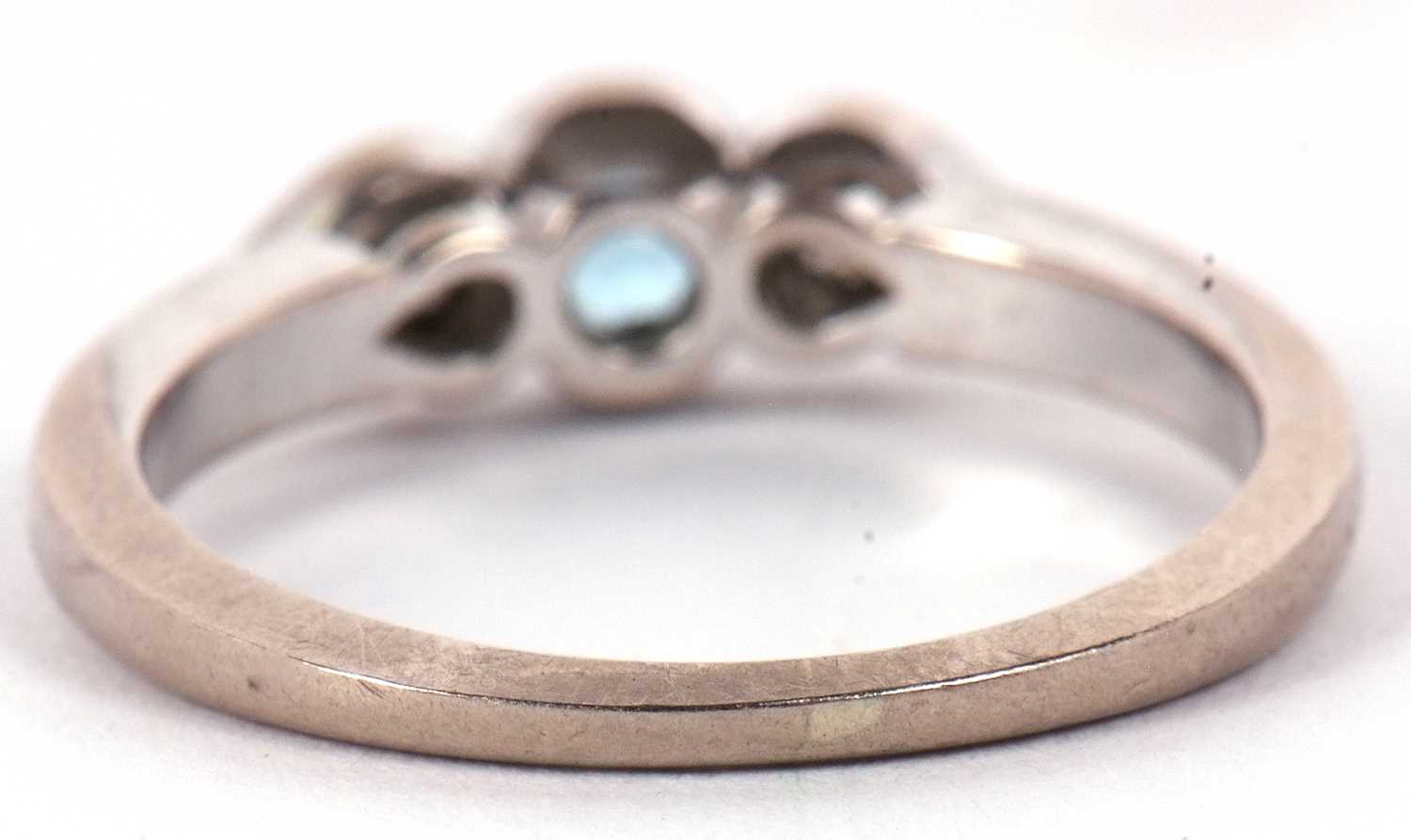 An 18ct white gold diamond and aquamarine ring, the central round aquamarine set to either side with - Image 4 of 10