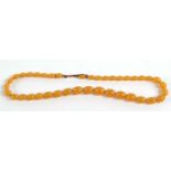 A butterscotch amber bead necklace, the graduated beads, between 6mm - 11mm, with unmarked yellow