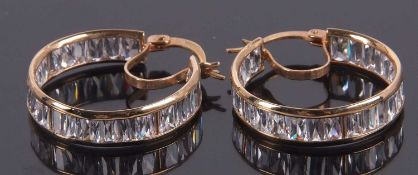 A pair of 9ct and CZ earrings, the hoops channel set with mixed cut CZ's, 6.2mm wide, with