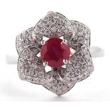 An 18ct ruby and diamond rose ring, the central round ruby surrounded by diamond pave set petals,