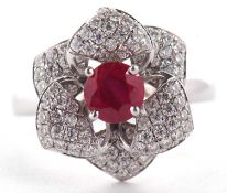 An 18ct ruby and diamond rose ring, the central round ruby surrounded by diamond pave set petals,