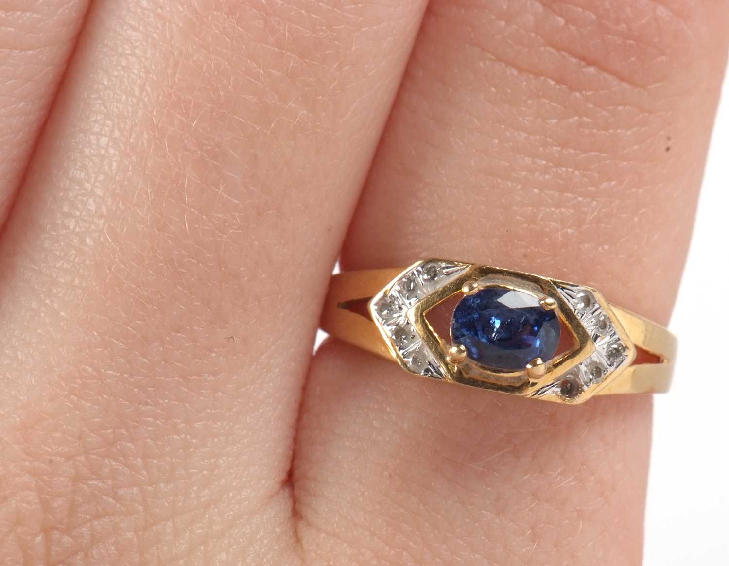 An 18ct sapphire and diamond ring, the central oval sapphire, set to either side with small round - Image 10 of 10