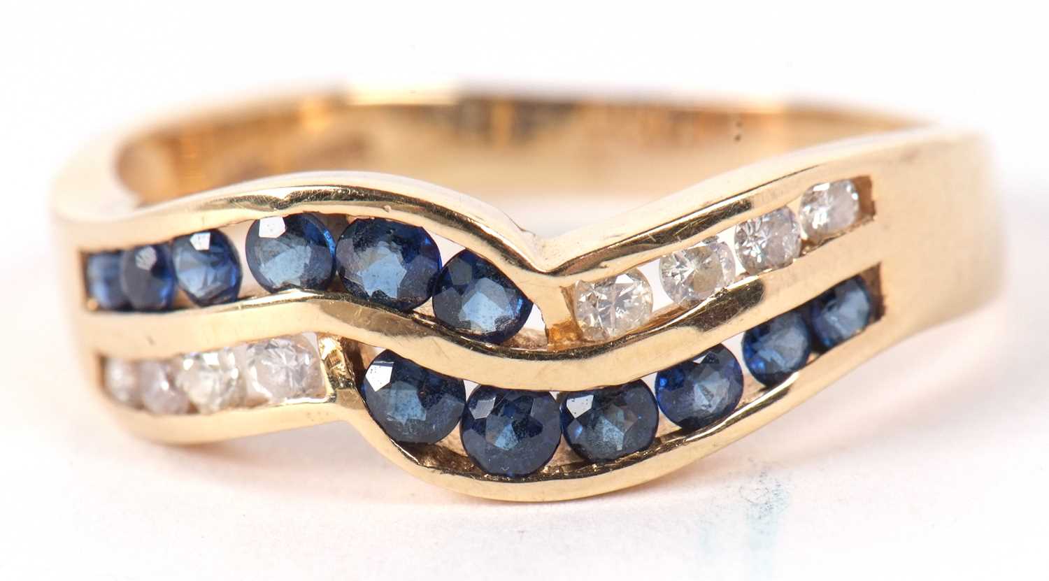 A 14ct sapphire and diamond ring, the two strand crossover style ring set with small round sapphires - Image 2 of 9