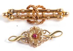 A 15ct bar brooch set with a red hardstone, stamped 15ct to reverse, 4cm long, 3.2g, together with