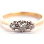 An 18ct three stone diamond ring, the three slightly graudated old mine cut diamonds, total