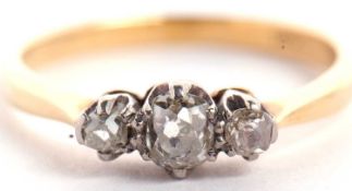 An 18ct three stone diamond ring, the three slightly graudated old mine cut diamonds, total