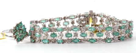 An emerald and silver bracelet and similar ring, the bracelet set with 3 rows of oval cut emeralds