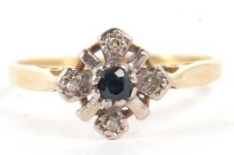 An 18ct sapphire and diamond ring, the central round sapphire with four illusion set diamonds in