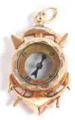 An anchor compass pendant, the round compass, glazed to both sides, set within a harpoon cross and