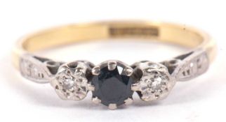 An 18ct and platinum sapphire and diamond ring, the central round sapphire set to either side with