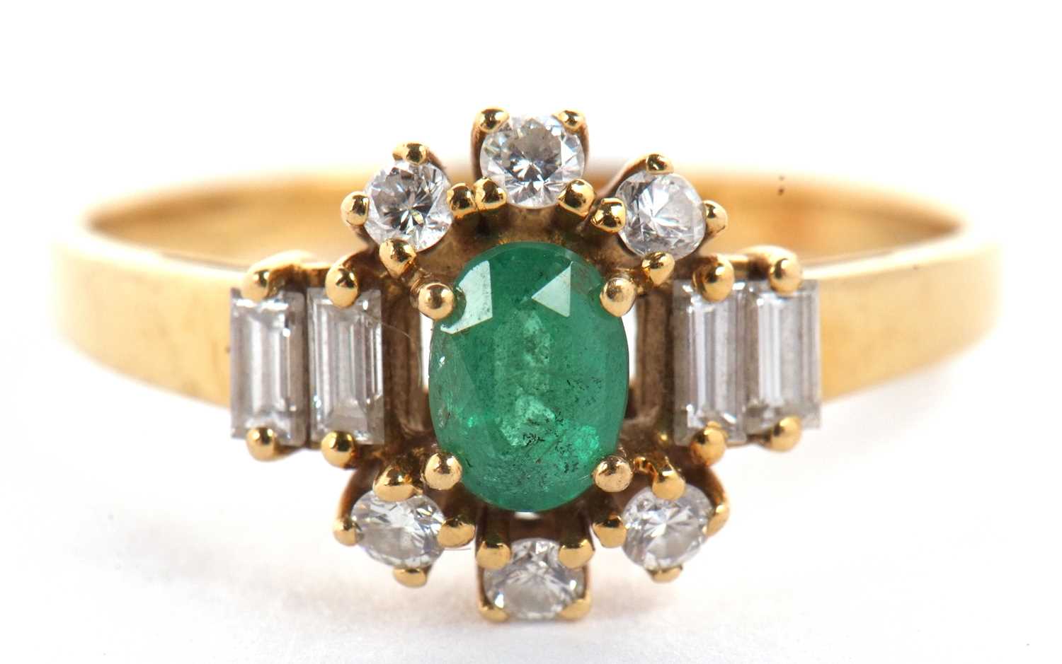 An 18ct emerald and diamond ring, the central oval emerald set with three small round diamonds above - Image 2 of 16