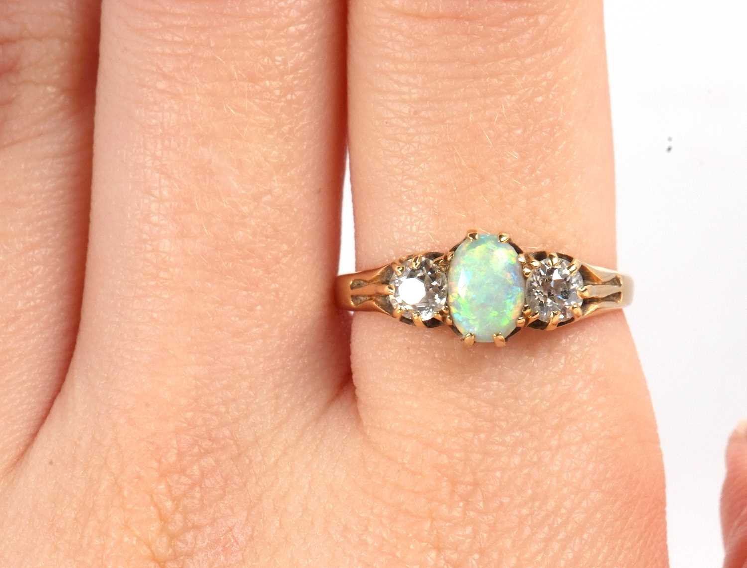 An opal and diamond ring, the oval opal set to either side with an old round brilliant cut - Image 10 of 10