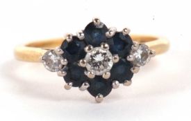 An 18ct sapphire and diamond ring, the central diamond surrounded by sapphire with a single