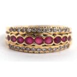 An 18ct ruby and diamond ring, the central row of round rubies, set above and below with a row of
