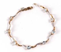 A 9ct topaz bracelet, the oval topaz, each approx. 4mm wide, claw mounted in yellow gold with