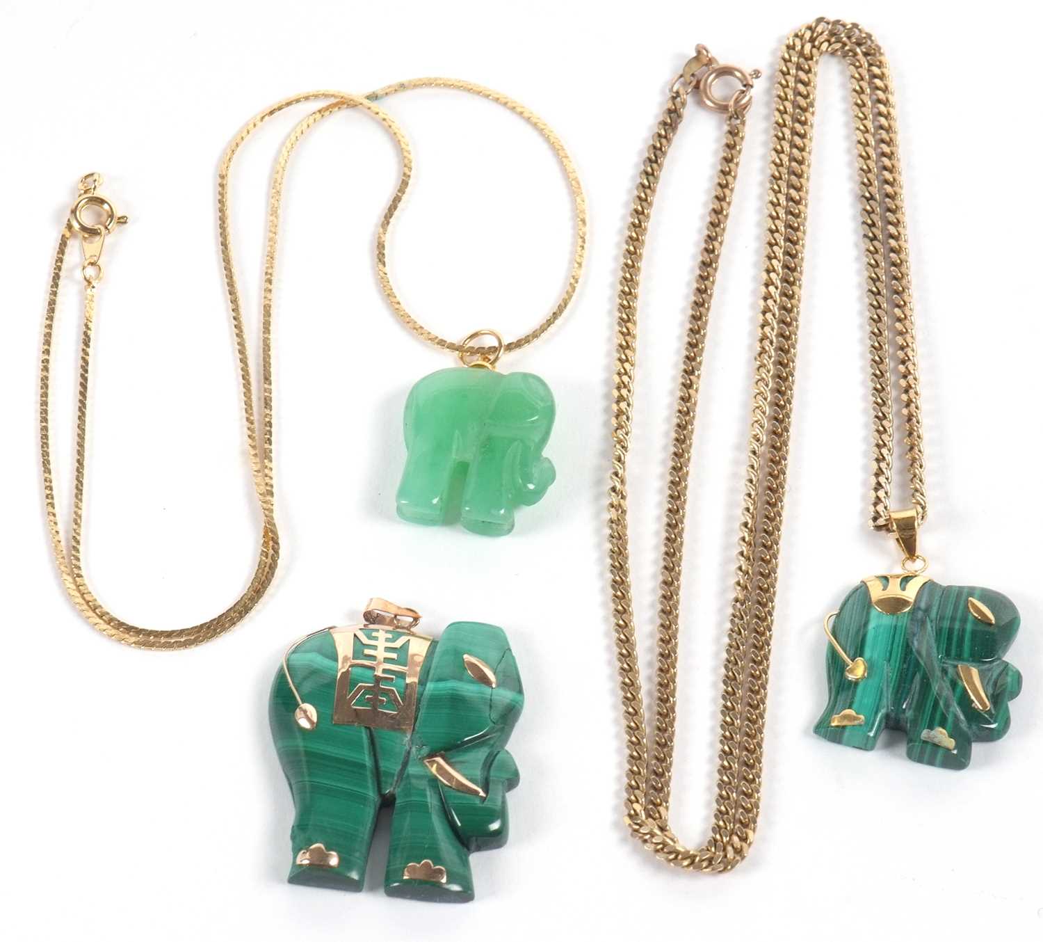 Three elephant pendants, the first a malachite pendant set with a Chinese character howdah, 3cm wide