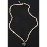 A freshwater cultured pearl necklace, a single row suspending a gilt metal heart pendant set with