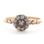 A diamond cluster ring, the cluster comprised of old mine cut diamonds set in white metal, to a