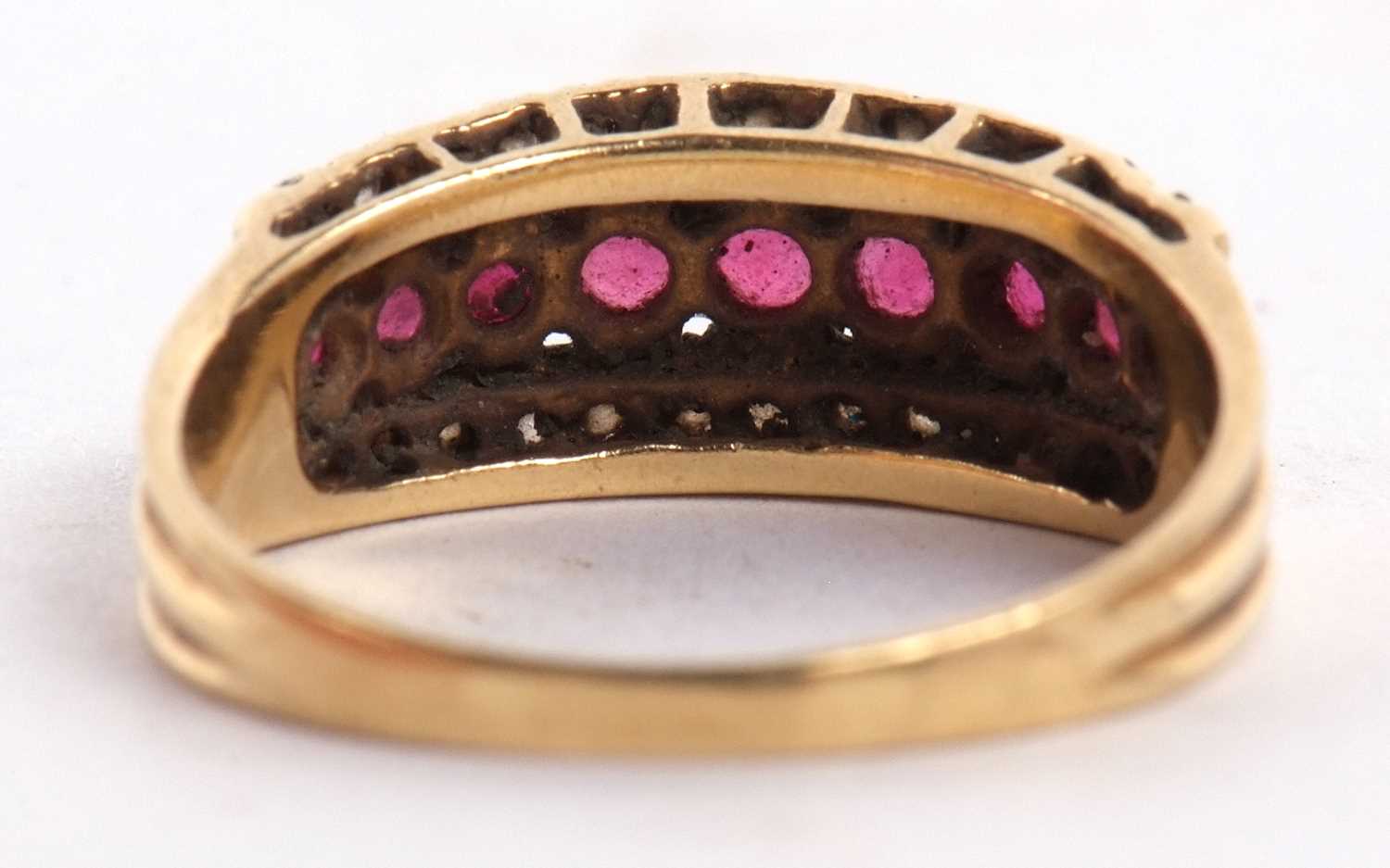 An 18ct ruby and diamond ring, the central row of round rubies, set above and below with a row of - Image 3 of 8