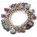 A silver and enamel charm bracelet, the curblinl bracelet with heart shaped padlock clasp stamped '