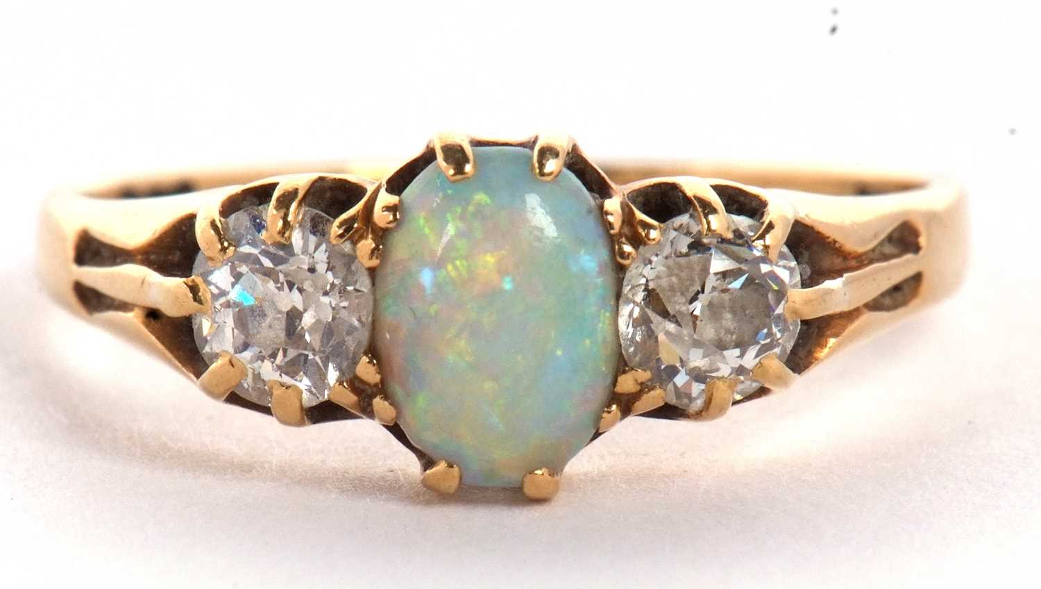 An opal and diamond ring, the oval opal set to either side with an old round brilliant cut - Image 3 of 10