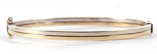 A 9ct hinged bangle, the two tone bangle stamped 375 and hallmarked London 2006, also stamped 9k