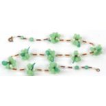 A vintage green glass and cultured pearl necklace featuring nine grape and vine leaf clusters,