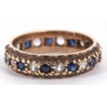 A 9ct gold full eternity ring alternate set with blue and white small stones, size L/M