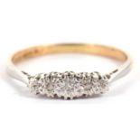 An 18ct and platinum diamond ring, the round graduated diamonds, illusion set to a plain band