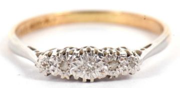 An 18ct and platinum diamond ring, the round graduated diamonds, illusion set to a plain band