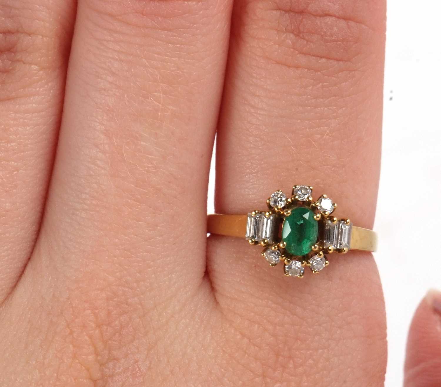 An 18ct emerald and diamond ring, the central oval emerald set with three small round diamonds above - Image 8 of 16