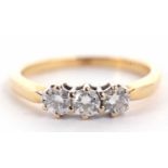 An 18ct three stone diamond ring, the three round brilliant cut diamonds, total weight extimated