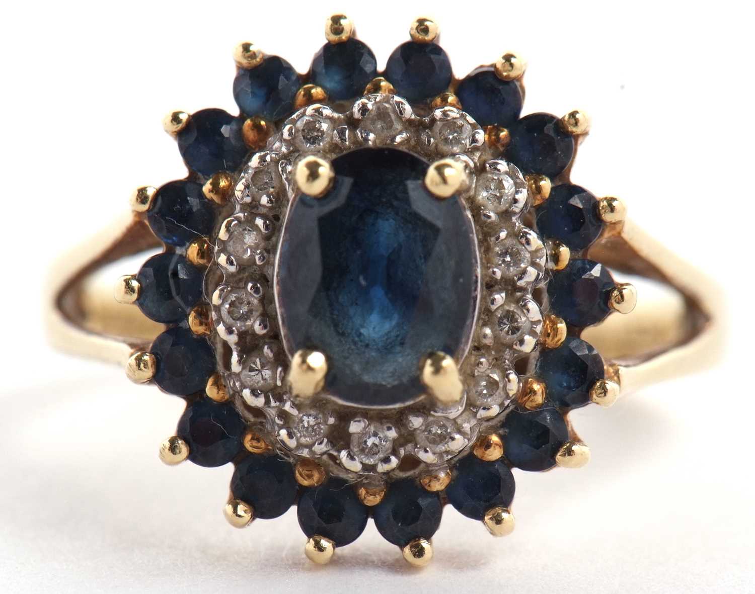 An 18ct sapphire and diamond cluster ring, the central oval sapphire surrounded by small round - Image 2 of 8
