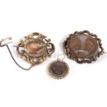 Two late Victorian hairwork memorial brooches and a pendant, to include an oval hairwork and seed