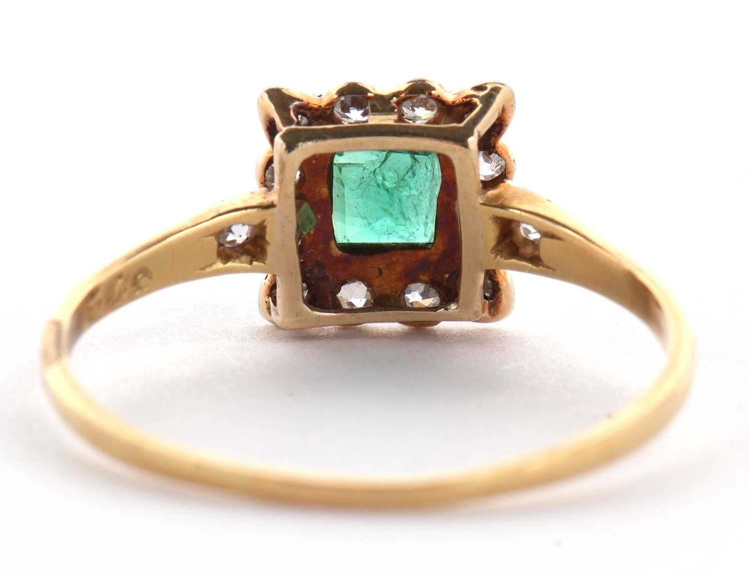 An emerald and diamond ring, the square step cut emerald, collet mounted with a surround of single - Image 4 of 11