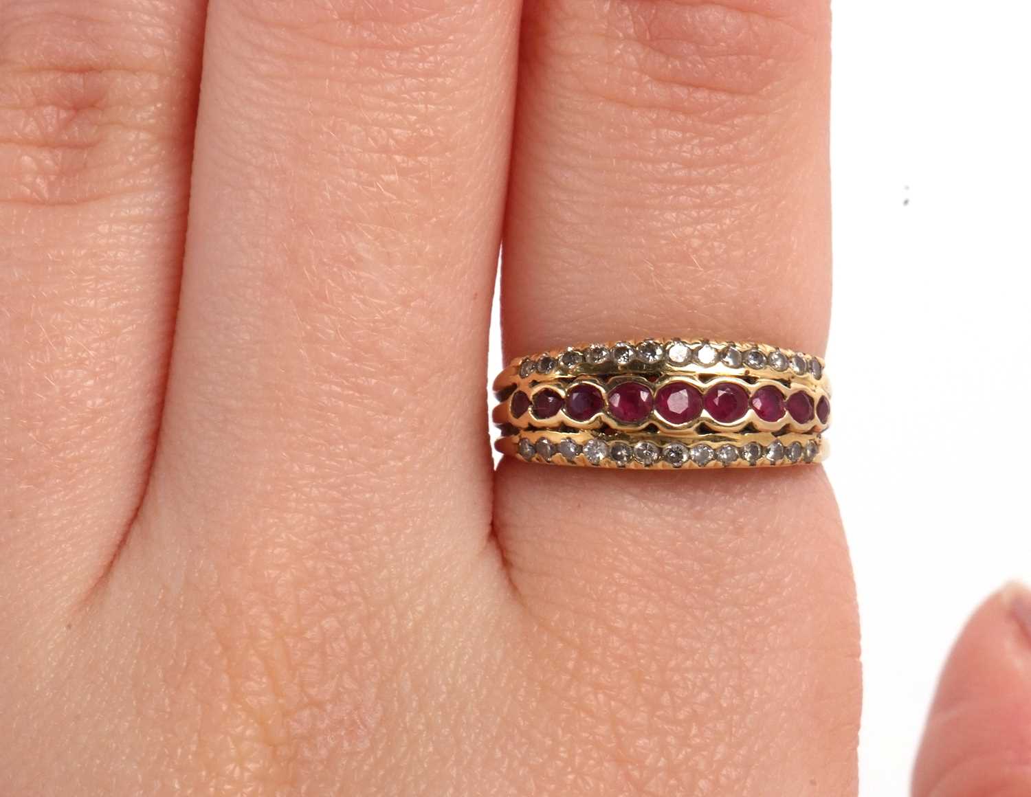 An 18ct ruby and diamond ring, the central row of round rubies, set above and below with a row of - Image 8 of 8