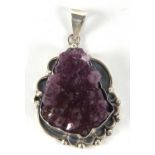 An amethyst crystal pendant, the amethyst crystal section in deep collet mount with asymetrical bead