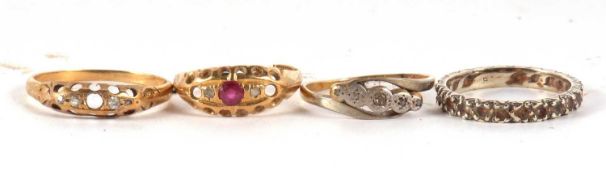 Four gemset rings, one stamped 18ct, one indistinctly stamped 9ct and two others with worn marks, (