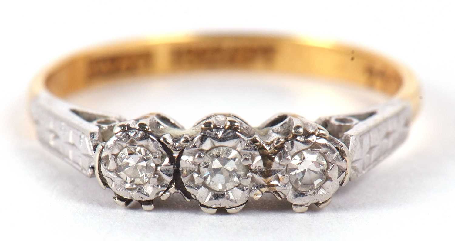 An 18ct and platinum diamond ring, the three round diamonds, illusion set to with engraved shoulders - Image 2 of 9