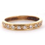 An 18ct half hoop diamond ring, the upper half set with round brilliant cut diamonds set within a