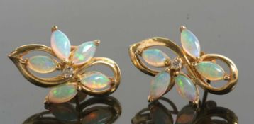 A pair of opal and diamond earrings, each earring set with four marquise shaped opal cabochons set