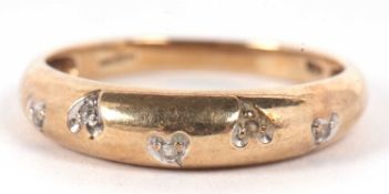 A 9ct diamond ring, the five small single cut diamonds set within heart shaped mounts to a plain