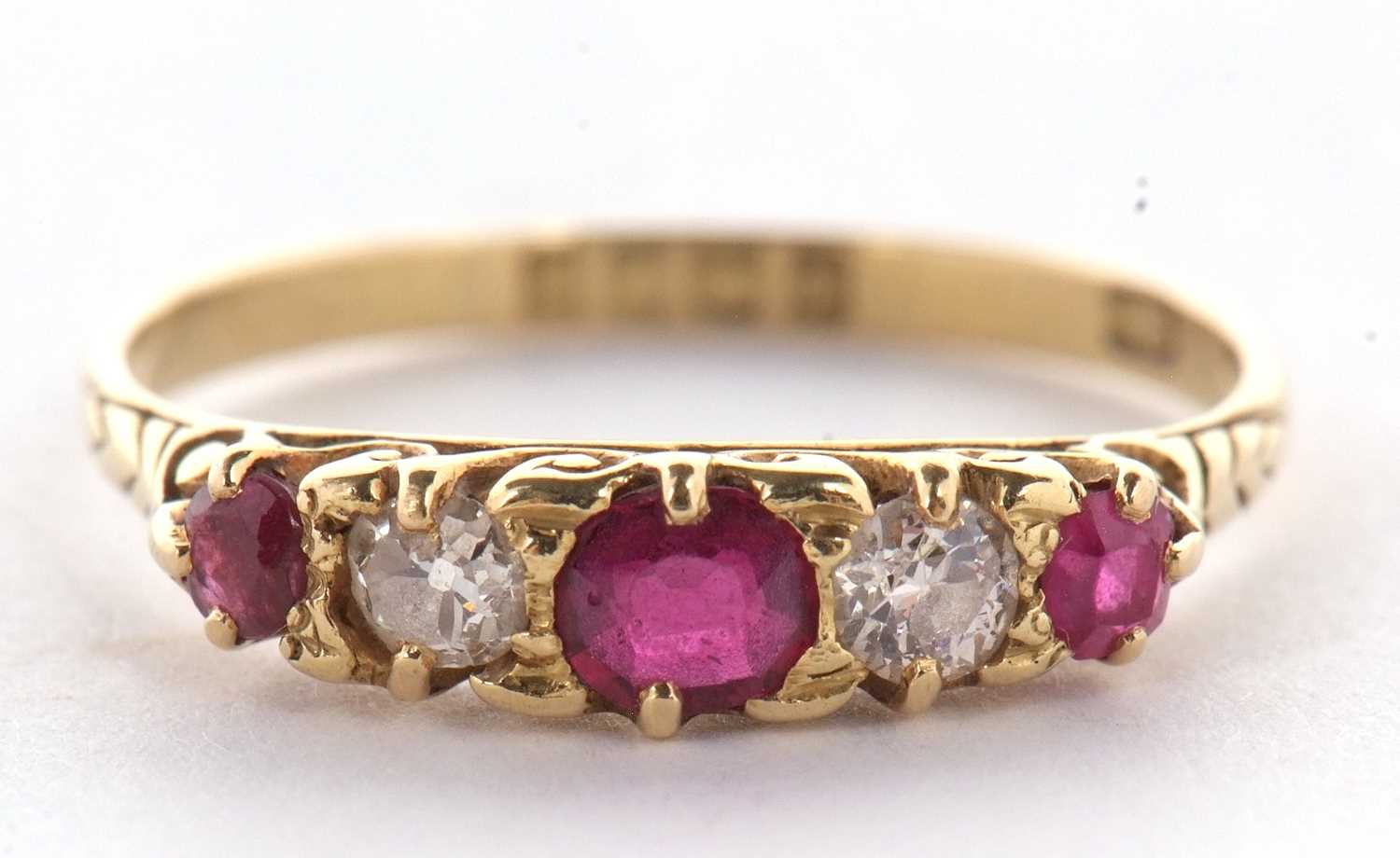 An early 20th century 18ct ruby and diamond ring, the alternating round, graduated rubies and