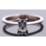 An 18ct white gold diamond solitaire ring, the 0.51ct emerald cut diamond, in a four claw setting to