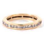 A diamond eternity ring, the full hoop ring set with princess cut diamonds, total estimated
