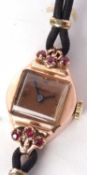 A lady's 9ct gold cased wristwatch, the square dial with Arabic and stud numerals and black hands,