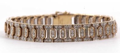 A 9ct diamond bracelet, the 9.5mm wide band set throughout with small round brilliant cut