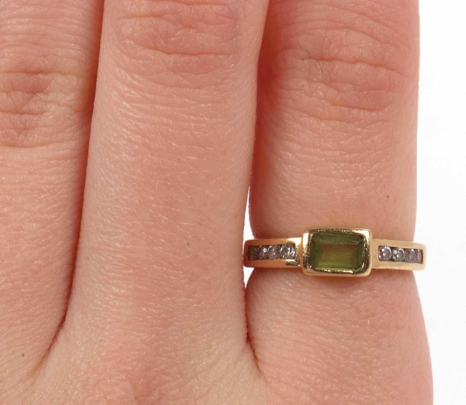 A peridot and diamond ring centering a rectangular cut peridot in rub over setting raised between - Image 6 of 6